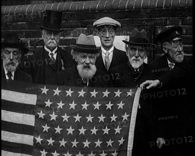 A Group of American Civil War Veterans Stand Together Holding the American Flag, 1924. Creator: British Pathe Ltd.