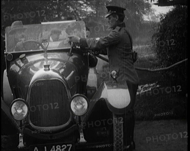 A British Automobile Association Employee Filling a Car With Petrol at a Petrol Station, 1920. Creator: British Pathe Ltd.