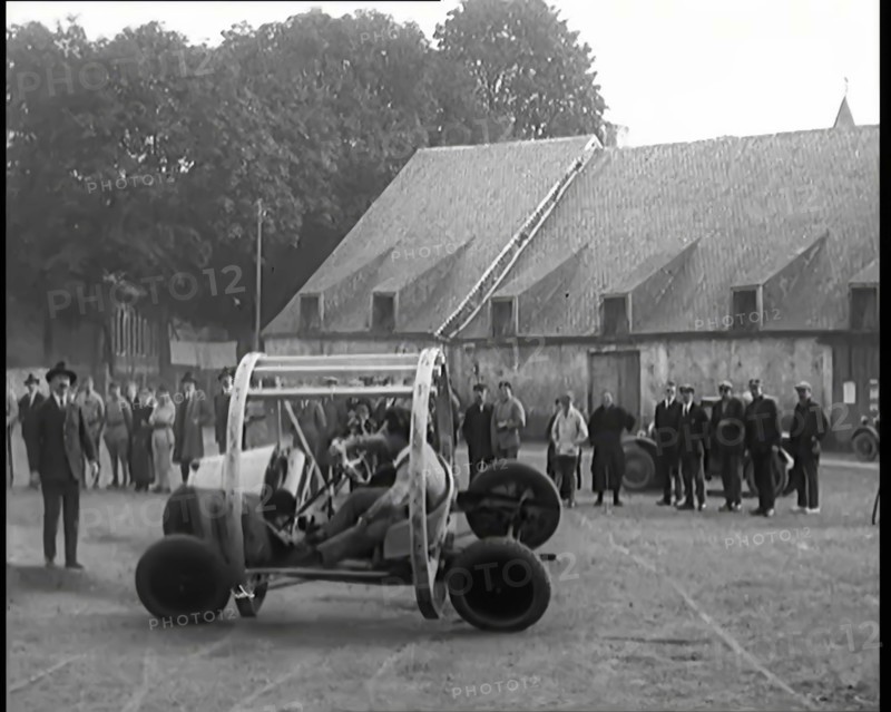 A Crashable Car With a Circular Frame Allowing It To Roll Over Being Tested in Front of..., 1926. Creator: British Pathe Ltd.