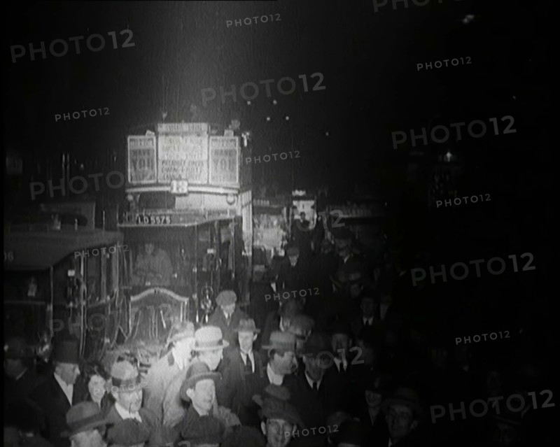 Buses and Crowds of People on a Busy London Street at Night, 1920s. Creator: British Pathe Ltd.