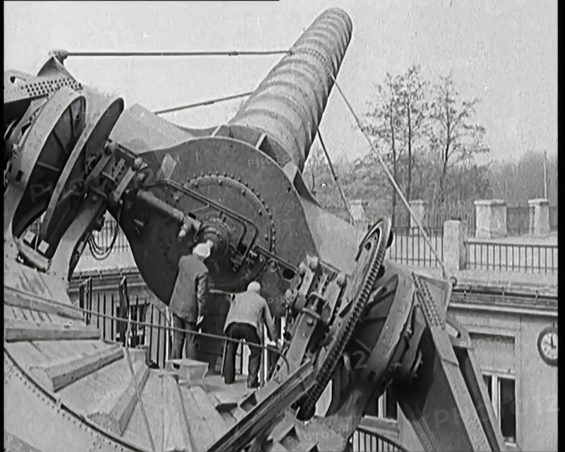 Large Telescope Being Turned by Two Civilians, 1931. Creator: British Pathe Ltd.