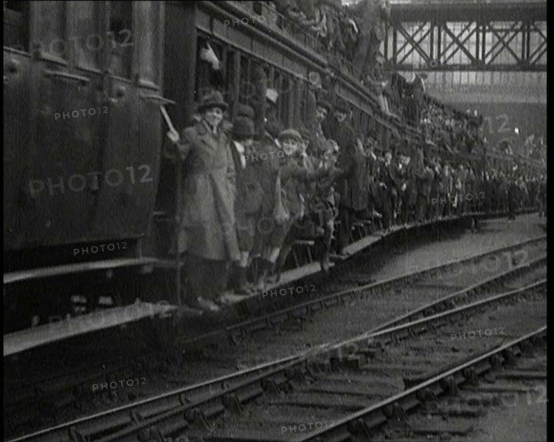 French People Hanging Onto the Outside of a Packed Train as It Drives Along, 1920. Creator: British Pathe Ltd.