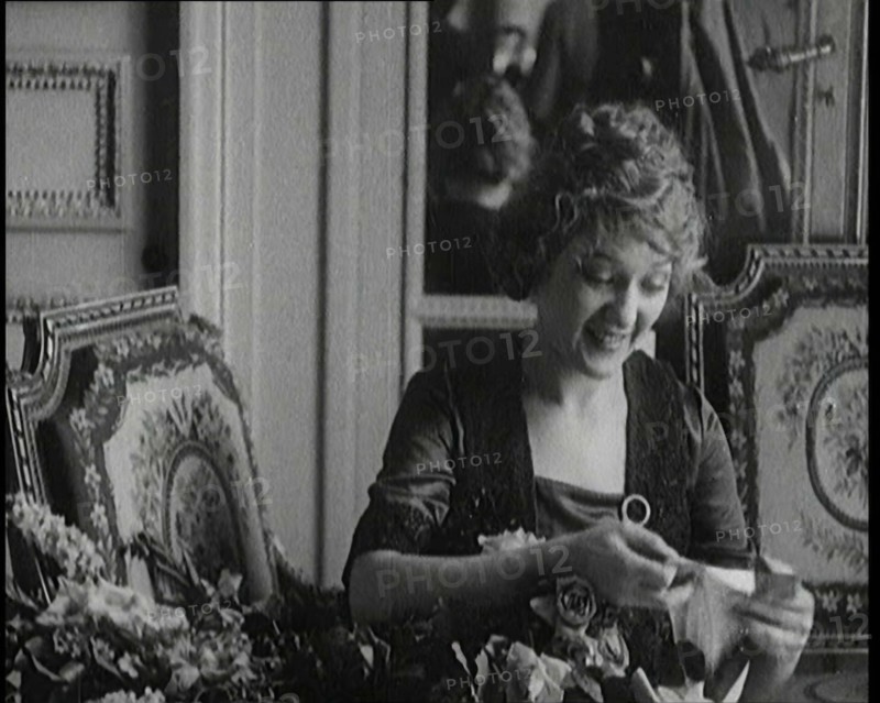Mary Pickford Talking and Sitting Amongst Flowers in Paris, 1920. Creator: British Pathe Ltd.