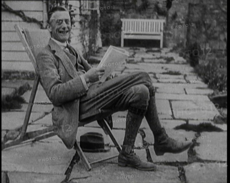 British Chancellor of the Exchequer Joseph Austen Chamberlain Reading a Newspaper While..., 1920. Creator: British Pathe Ltd.