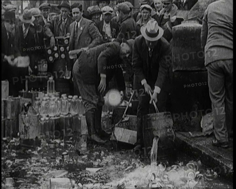 Prohibition Scenes in the United States of America. Men Smashing Bottles of Alcoholic..., 1920. Creator: British Pathe Ltd.