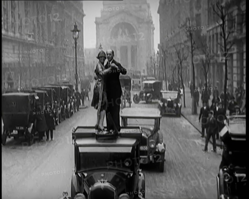 A Couple Dancing the Charleston on the Top of a Car Driving Down a London Street, 1926. Creator: British Pathe Ltd.