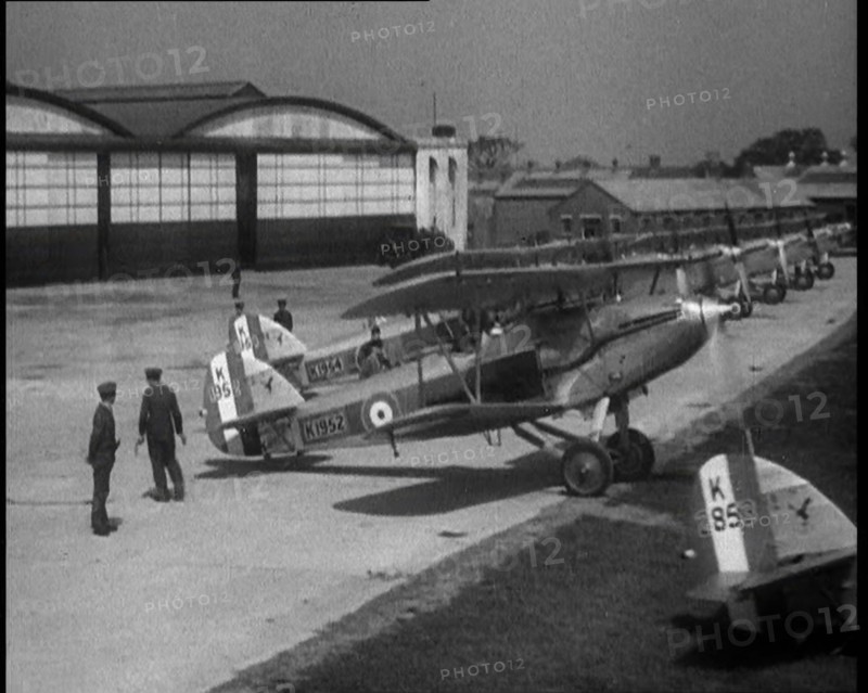 RAF Biplanes Taxiing Across a Field at tended to by Their Aircrews, 1933. Creator: British Pathe Ltd.