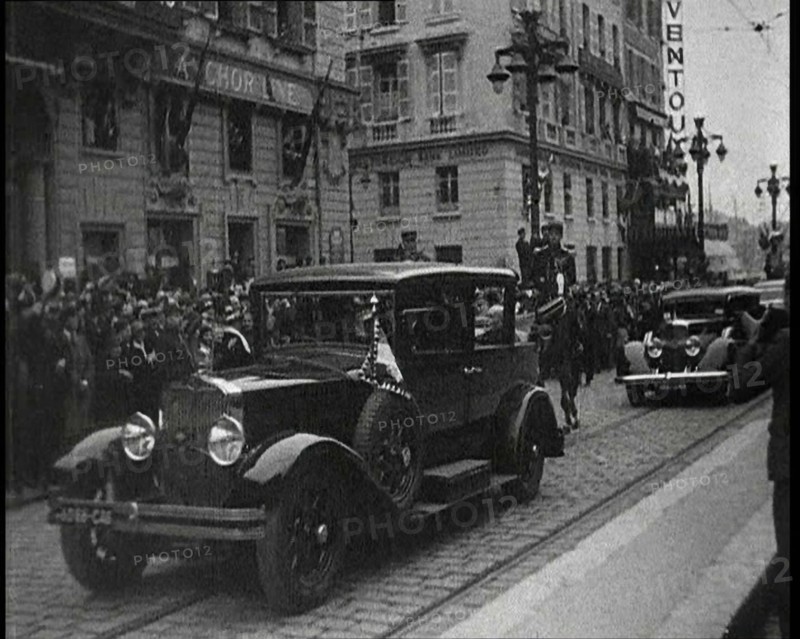 Cars Driving Down a Road, Watched by a Crowd, 1934. Creator: British Pathe Ltd.