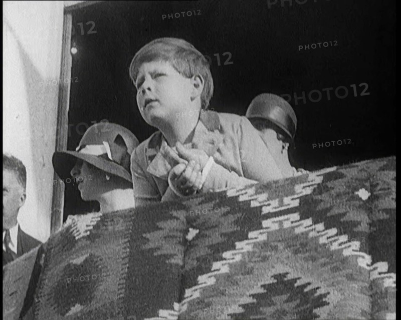 King Michael of Romania  Leans Over a Balcony. Behind Him are Two Female Civilians, 1924. Creator: British Pathe Ltd.