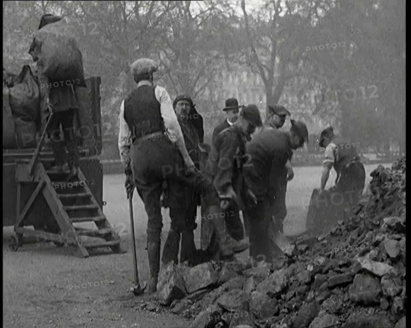 Male Civilian Volunteers Shovelling Heaps of Coal in Hyde Park London, 1926. Creator: British Pathe Ltd.