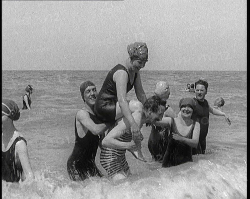 Group of Four Female Civilians and One Male Civilian in Bathing Suits Playing in the Sea..., 1924. Creator: British Pathe Ltd.
