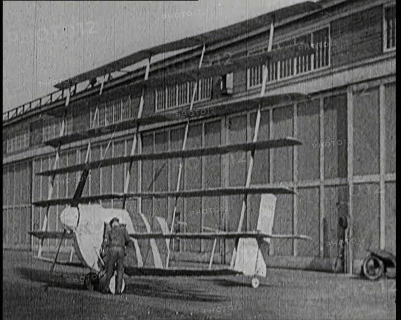 A Male Pilot Getting Into an Early Seven Winged Plane, 1922. Creator: British Pathe Ltd.