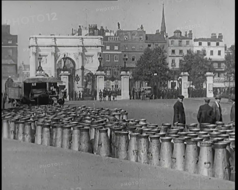 Milk Churns Lining the Street, 1926. Creator: British Pathe Ltd.