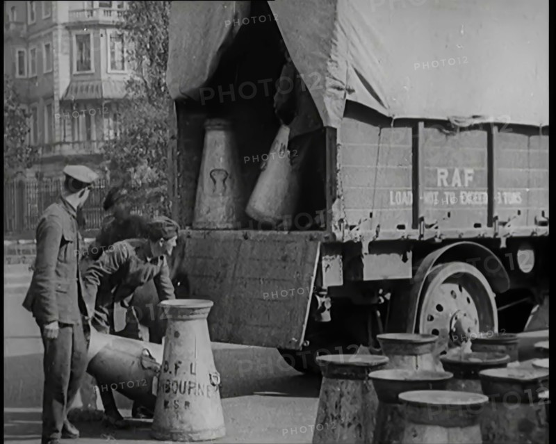 Milk Churns Being Loaded Onto a Lorry by Male Soldiers, 1926. Creator: British Pathe Ltd.