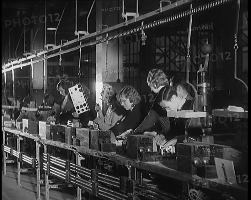 Female Civilians Working on a Factory Production Line, 1931. Creator: British Pathe Ltd.