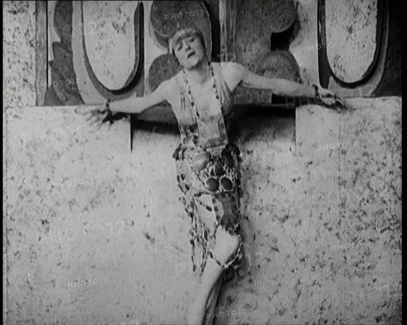 A Female Actor Chained to a Wall for a Performance, She Is Wearing a Glamorous Dress, 1922. Creator: British Pathe Ltd.