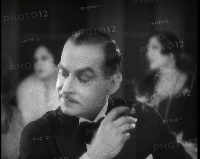Scene from the Film 'Champagne': a Male Actor in a Nightclub Smoking a Cigarette, 1920s. Creator: British Pathe Ltd.