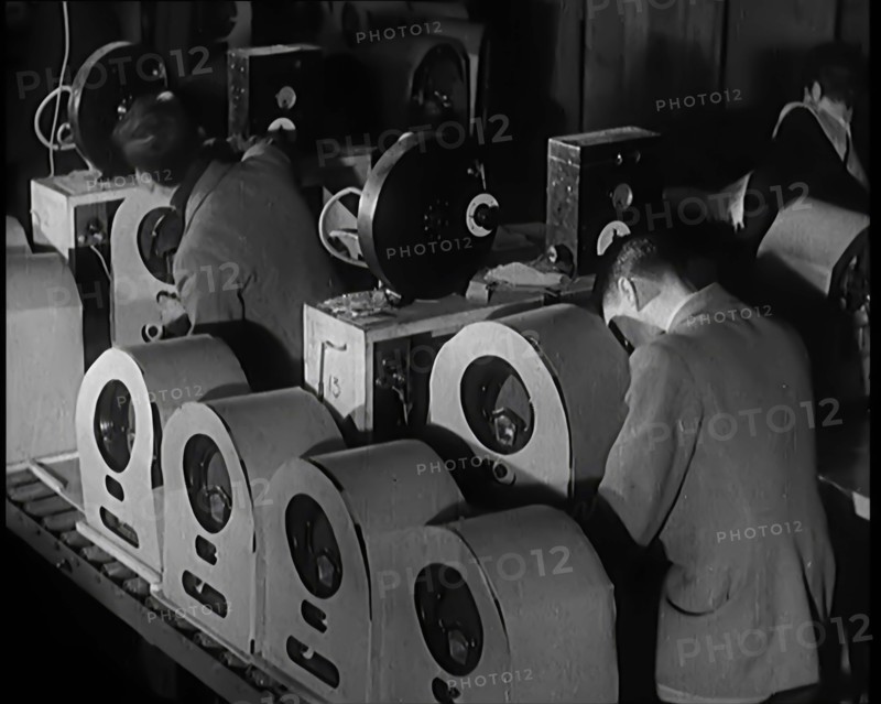 Male and Female Civilians Building Radio Wireless Sets in a Factory, 1931. Creator: British Pathe Ltd.
