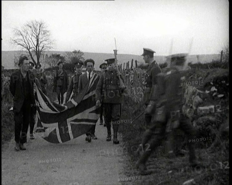 British Soldiers Marching a Sinn Fein Supporter Down a Country Lane, Forcing Him to Bear..., 1920. Creator: British Pathe Ltd.