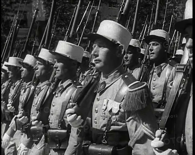 Male French Foreign Legion Soldiers Marching in a Bastille Day Military Parade, 1939. Creator: British Pathe Ltd.