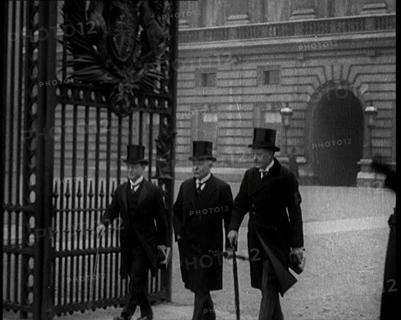 Three Male British Members of Parliament Walking Away from Buckingham Palace, Passing..., 1924. Creator: British Pathe Ltd.