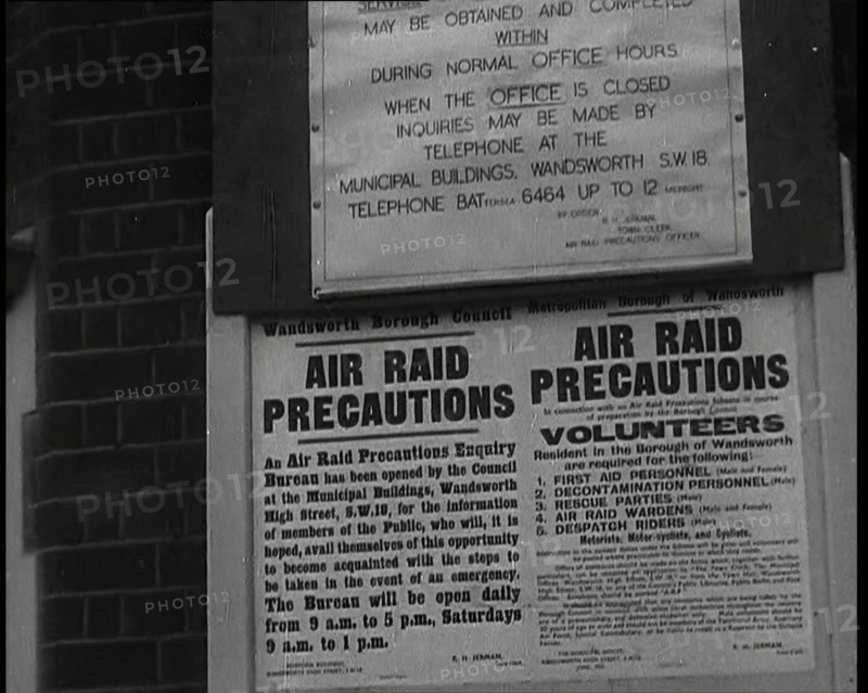 Notices Containing Information About 'Air Raid Precautions' and Asking For Volunteers..., 1938. Creator: British Pathe Ltd.