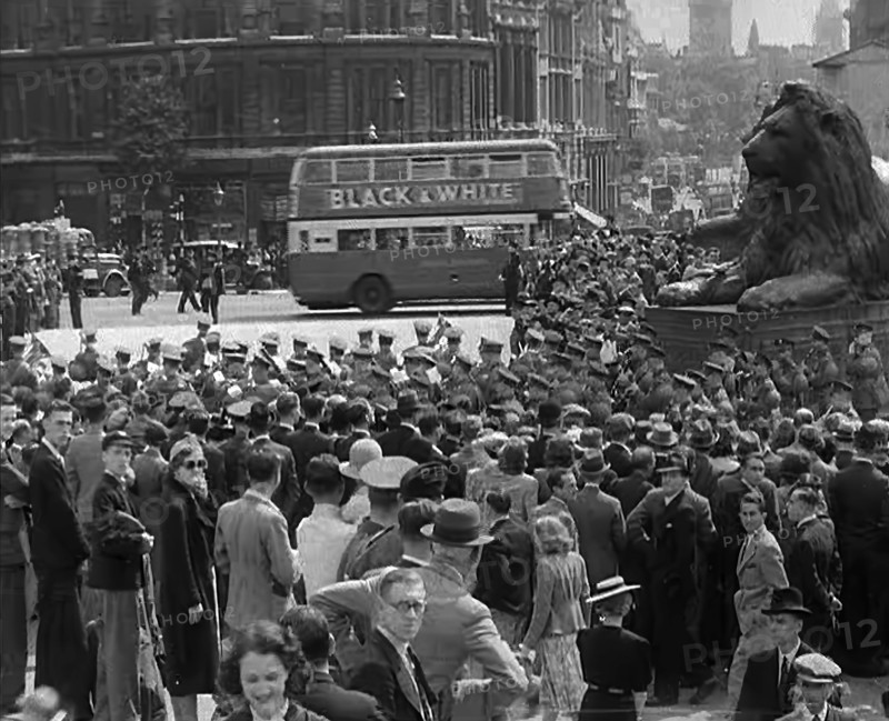 Crowds Watching a Military Band March in Trafalgar Square, 1940. Creator: British Pathe Ltd.