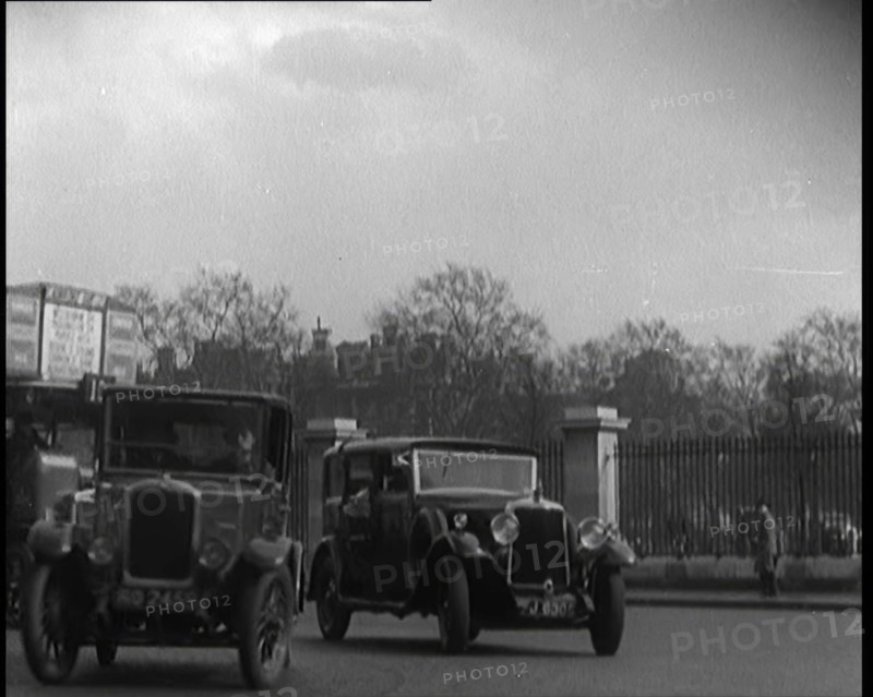 London Bus, Cars and Taxis Turning a Corner on a London Street, 1924. Creator: British Pathe Ltd.