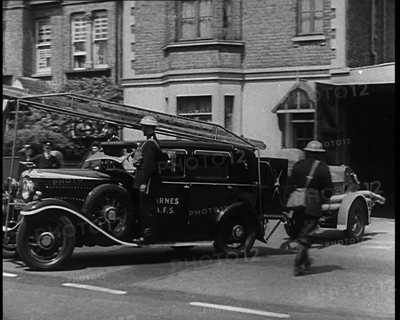 A Car With a Fire Hose attached Driving Away, 1940. Creator: British Pathe Ltd.