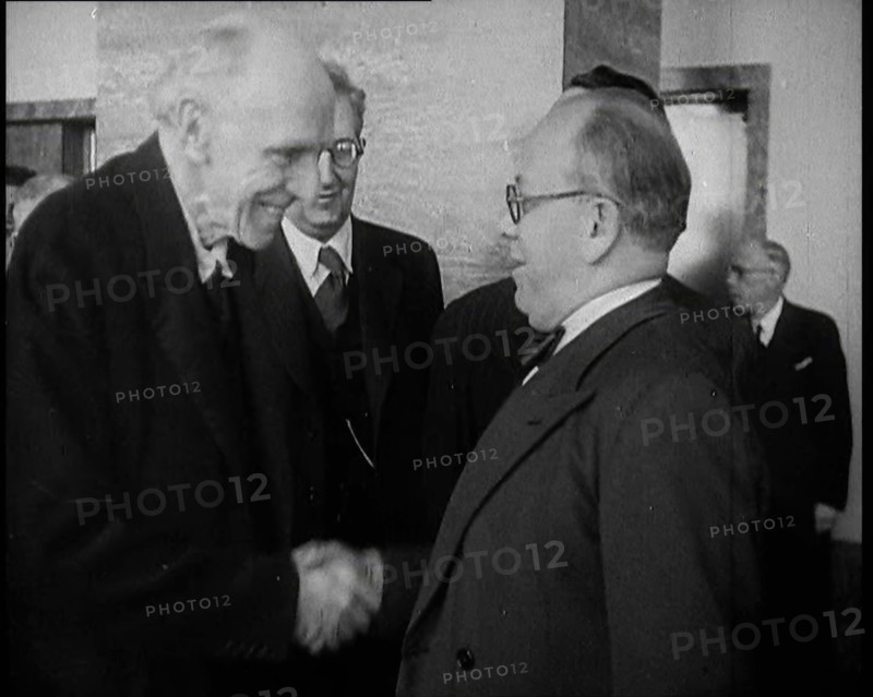 Two Male League of Nations Delegates Greeting Each Other By Shaking Hands While Two Other..., 1937. Creator: British Pathe Ltd.