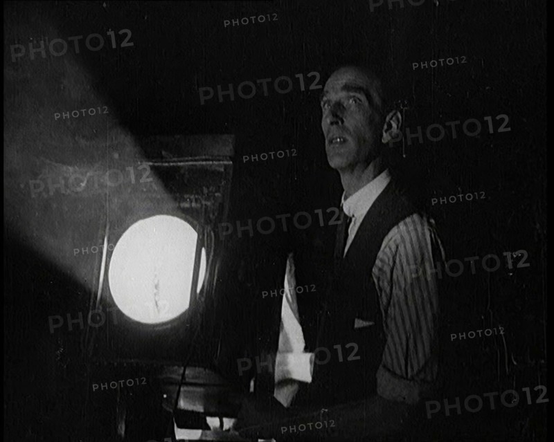 Male Civilian Stands Next to a Large Light, 1920s. Creator: British Pathe Ltd.