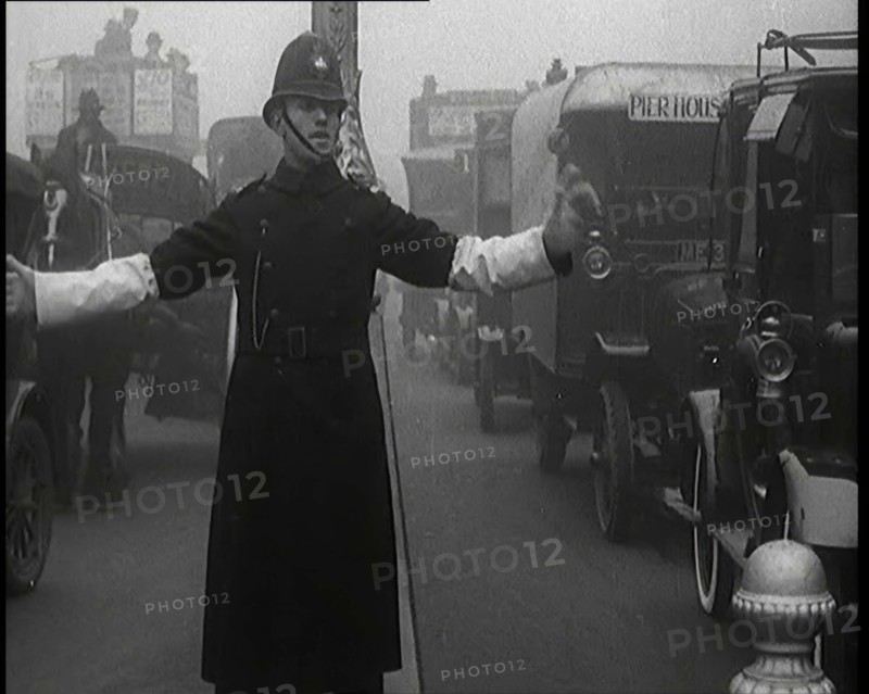 Male British Police Officer Controlling the Traffic On the Streets of London, 1920s. Creator: British Pathe Ltd.