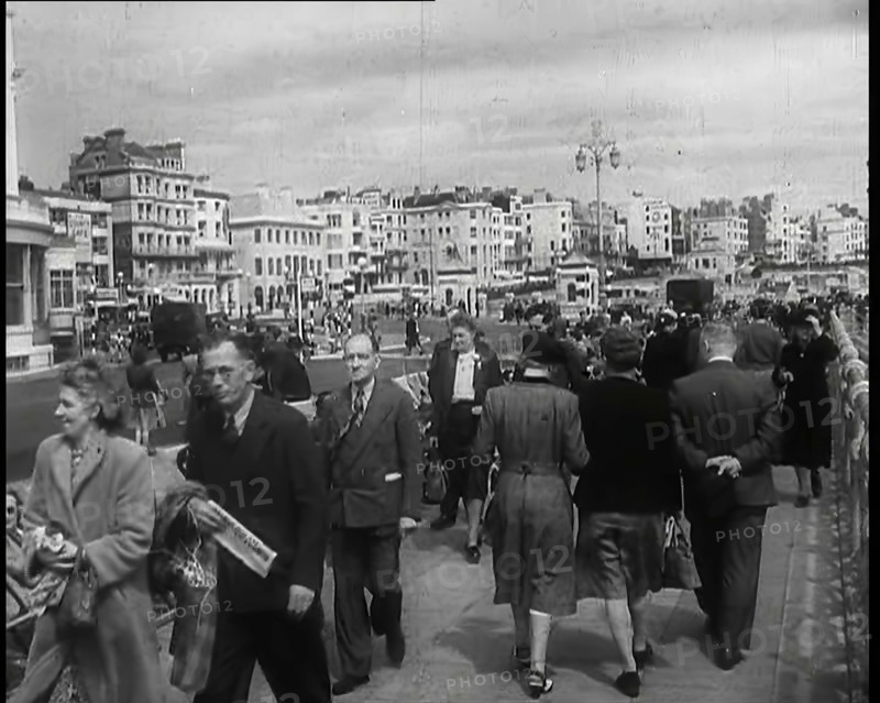 A Cloudy Day as Male and Female Pedestrians are Walking on the Promenade at  Brighton..., 1939. Creator: British Pathe Ltd.