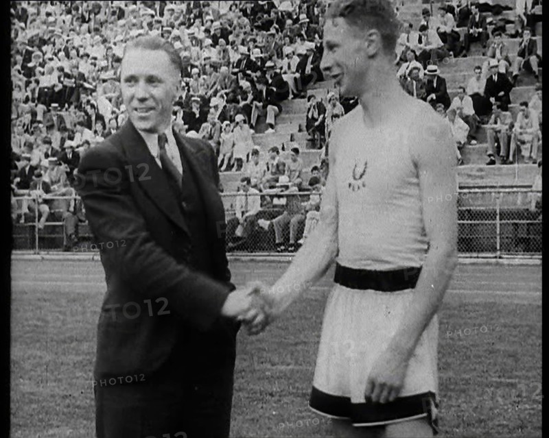 Jack Lovelock Shaking Hands With Someone as Crowds Watch, 1930s. Creator: British Pathe Ltd.