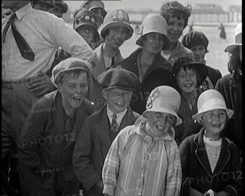 A Group of Male and Female Children Laughing as They Are Watching a Film Being Made, 1920s. Creator: British Pathe Ltd.