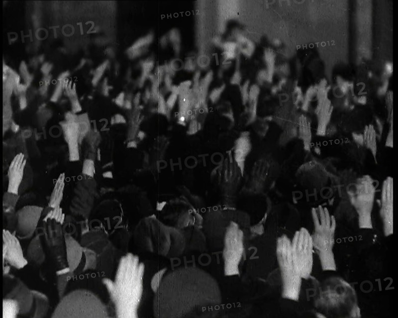 Crowd With Right Arms Raised in a Nazi Salute in the Direction of the..., 1937. Creator: British Pathe Ltd.