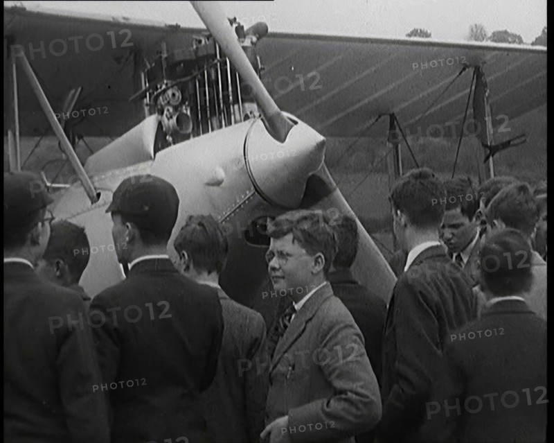 A Group of Young Male British Civilians Admiring an Airplane On an Airfield, 1920s. Creator: British Pathe Ltd.