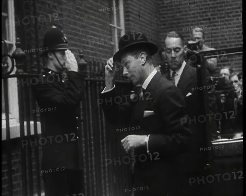 A Male British Police Officer Saluting King George VI, the British Monarch who is Exiting..., 1939. Creator: British Pathe Ltd.