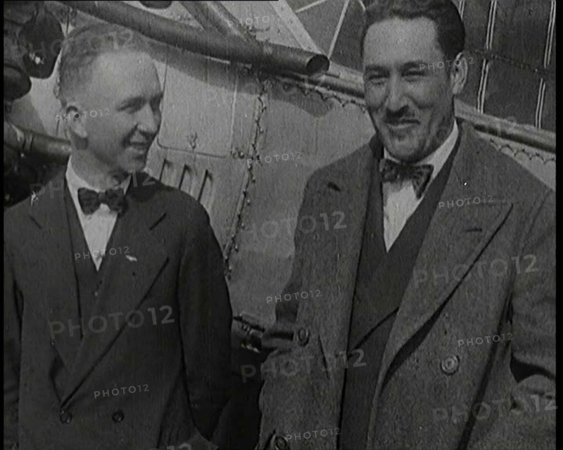 Clarence Duncan Chamberlin And Bertrand Blanchard Acosta Talking in Front of an Airplane, 1920s. Creator: British Pathe Ltd.
