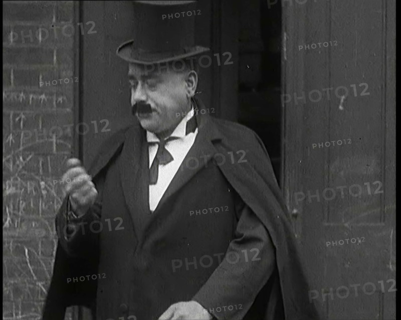 Theatre Star Billy Bennett Walking Out of a Doorway..., 1920s Creator: British Pathe Ltd.