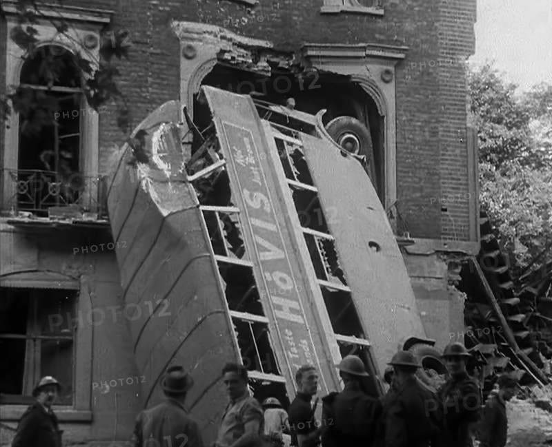 People Standing Next to a Bombed Out Bus, 1940. Creator: British Pathe Ltd.