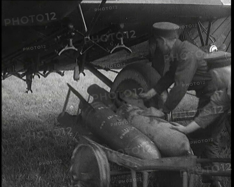 Male British Officers Loading Bombs Onto a Plane, 1920s Creator: British Pathe Ltd.