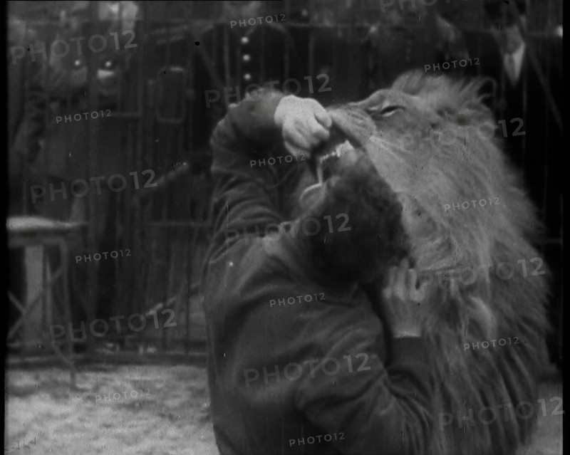 Man Sticking his Head in a Lion’s Mouth, 1930s. Creator: British Pathe Ltd.
