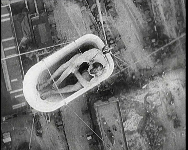 A Male Civilian Sitting in a Bath Lifted Off the Ground By a Hot Air..., 1920s. Creator: British Pathe Ltd.