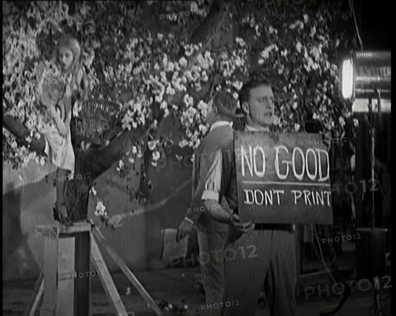 Female Actor Sitting in a Blossom Tree Whilst a Male Civilian Talks to Her..., 1920s. Creator: British Pathe Ltd.