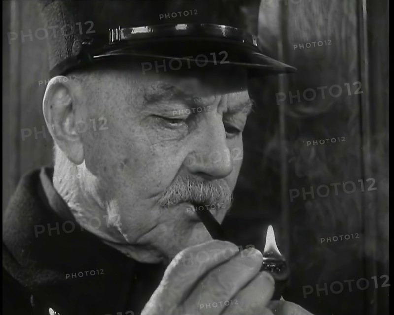 Close up on Male British Chelsea Pensioner as He is Lighting a Pipe, 1939. Creator: British Pathe Ltd.