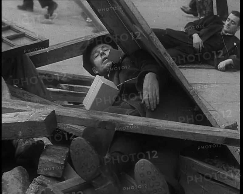 British People Acting Out Bomb attacks and Crashed German Planes, Lying Under Rubble, 1940. Creator: British Pathe Ltd.