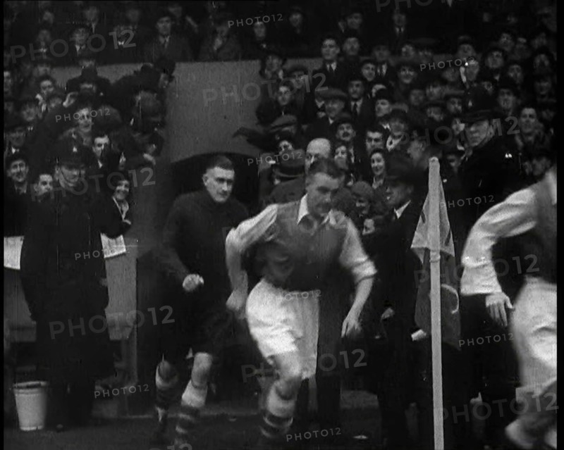 Crowds Watching Football Players Running onto the Football Pitch, 1930s. Creator: British Pathe Ltd.