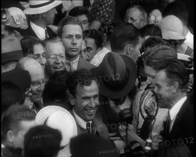 Jim Mollison Walking Surrounded by a Large Crowd, 1930s. Creator: British Pathe Ltd.