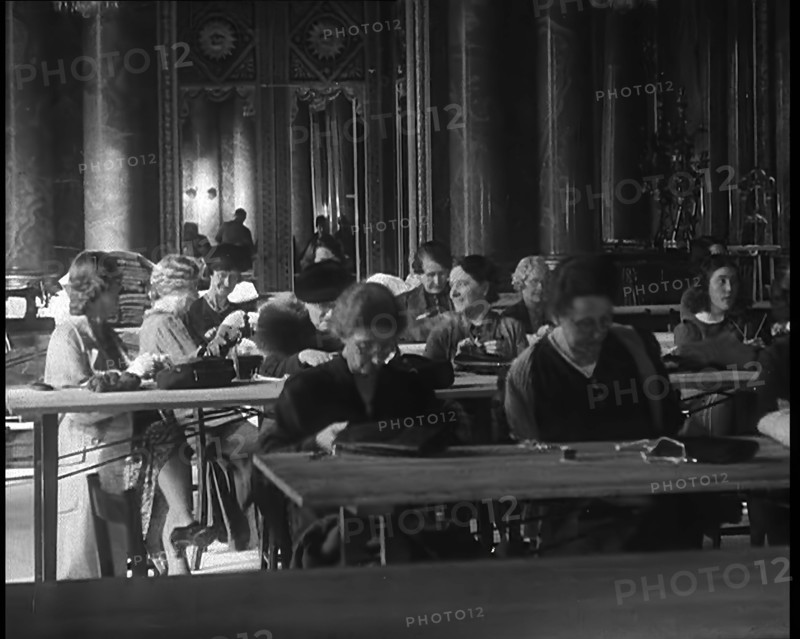Buckingham Palace Hosting a Sewing Group. Large Numbers of Women Sewing or Knitting, 1940. Creator: British Pathe Ltd.